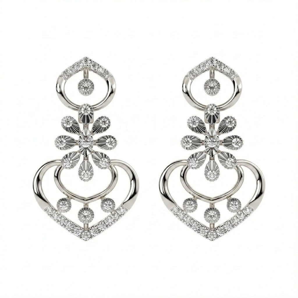 A pair of white gold and diamond earrings, featuring a heart-shaped design with floral and circular details, set against a plain white background.