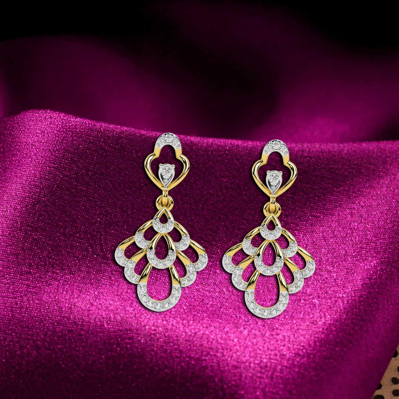 A pair of  gold earrings with sparkling diamond accents, featuring a leaf-like design with a heart-shaped top.