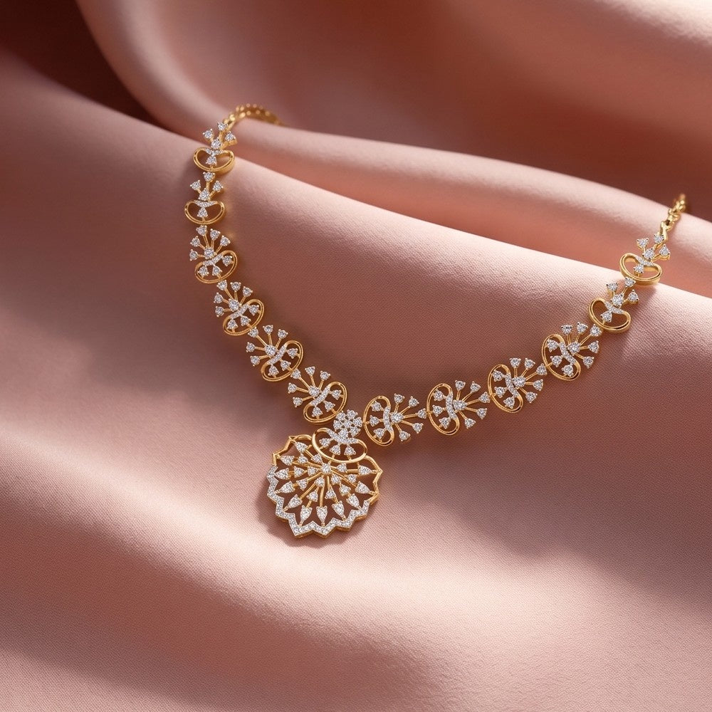 Gold necklace with diamond accents on a soft pink fabric background