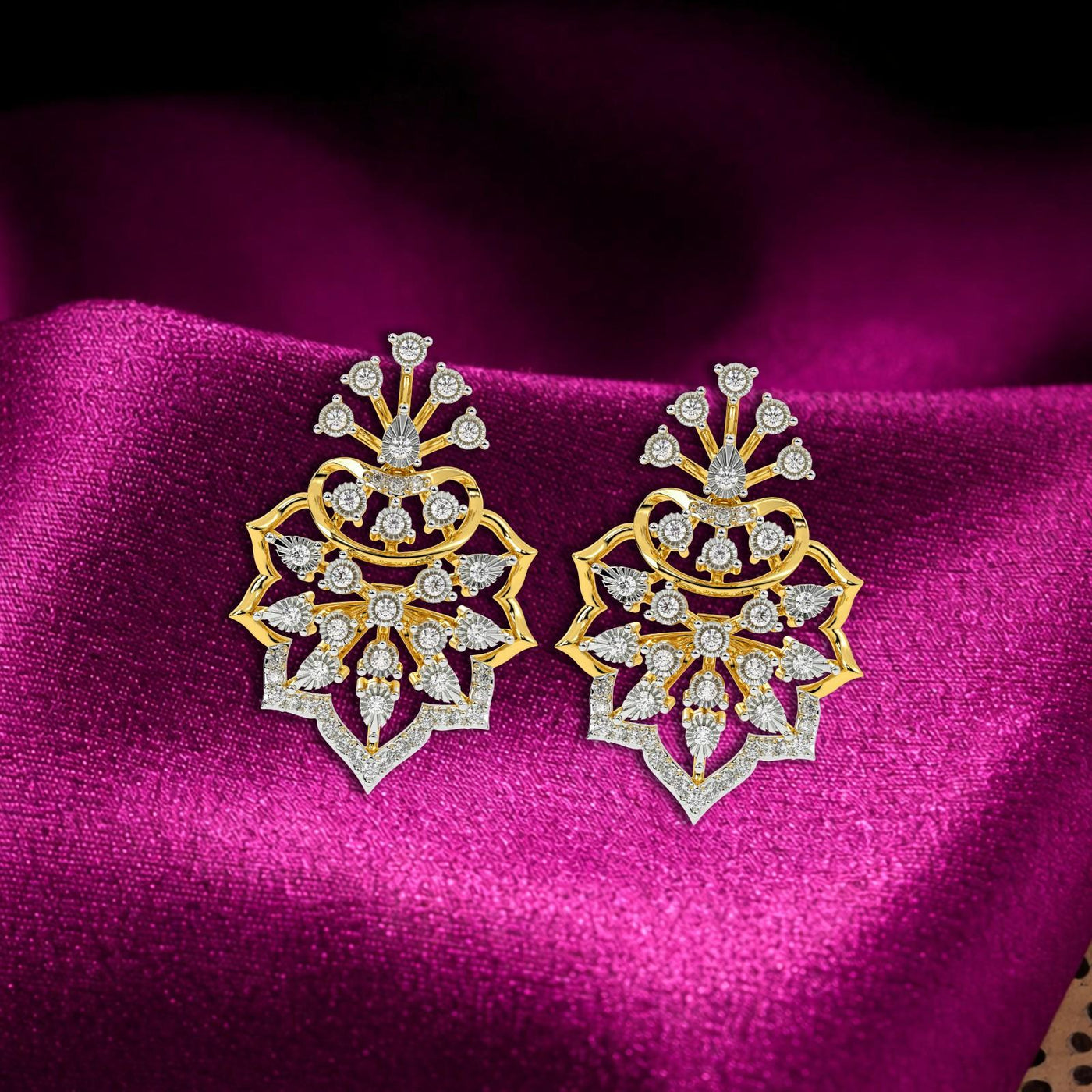 A pair of ornate, yellow gold drop earrings with intricate, layered, floral-inspired designs.