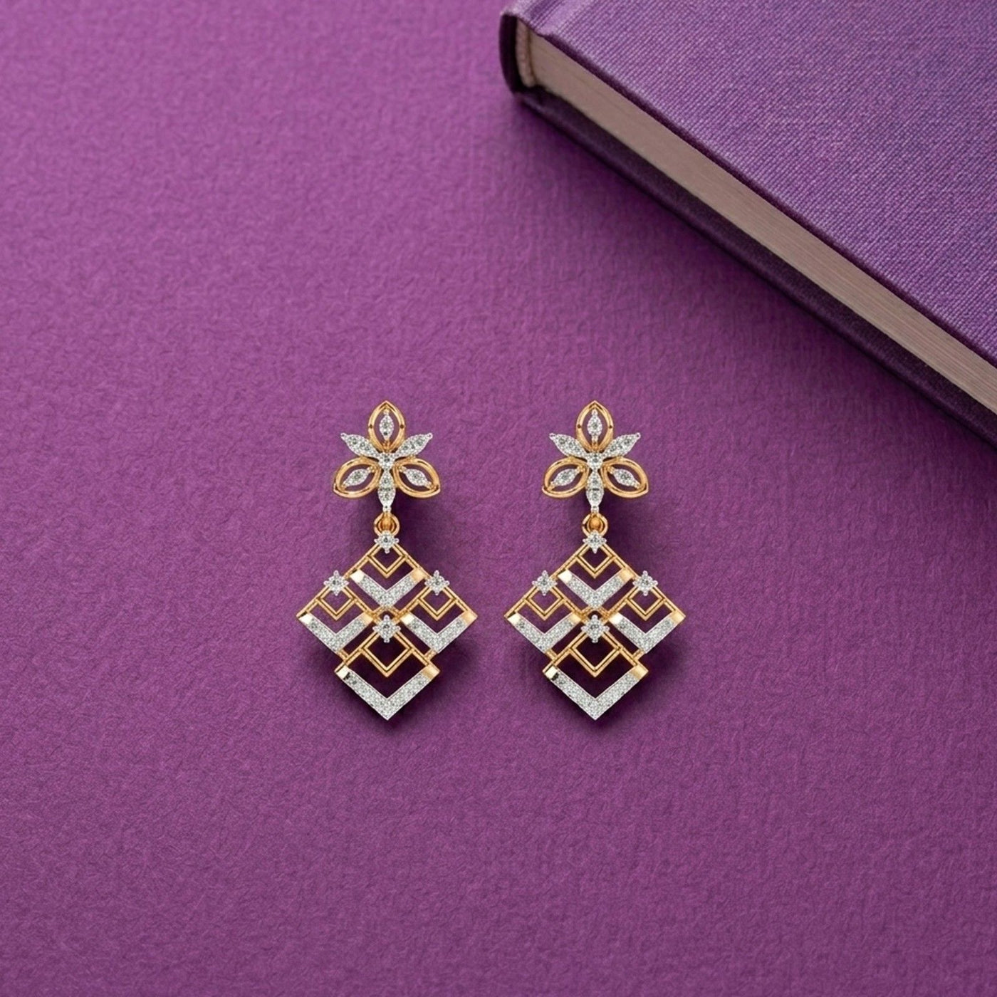 A pair of yellow gold and diamond dangle earrings featuring a floral top and a geometric drop