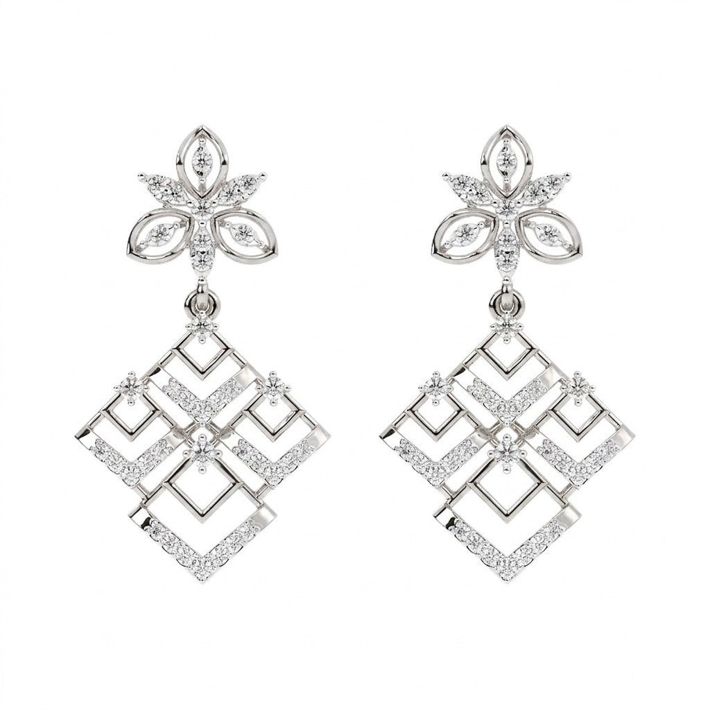 A pair of white gold and diamond dangler earrings, featuring a floral stud top and a geometric diamond-shaped dangle.