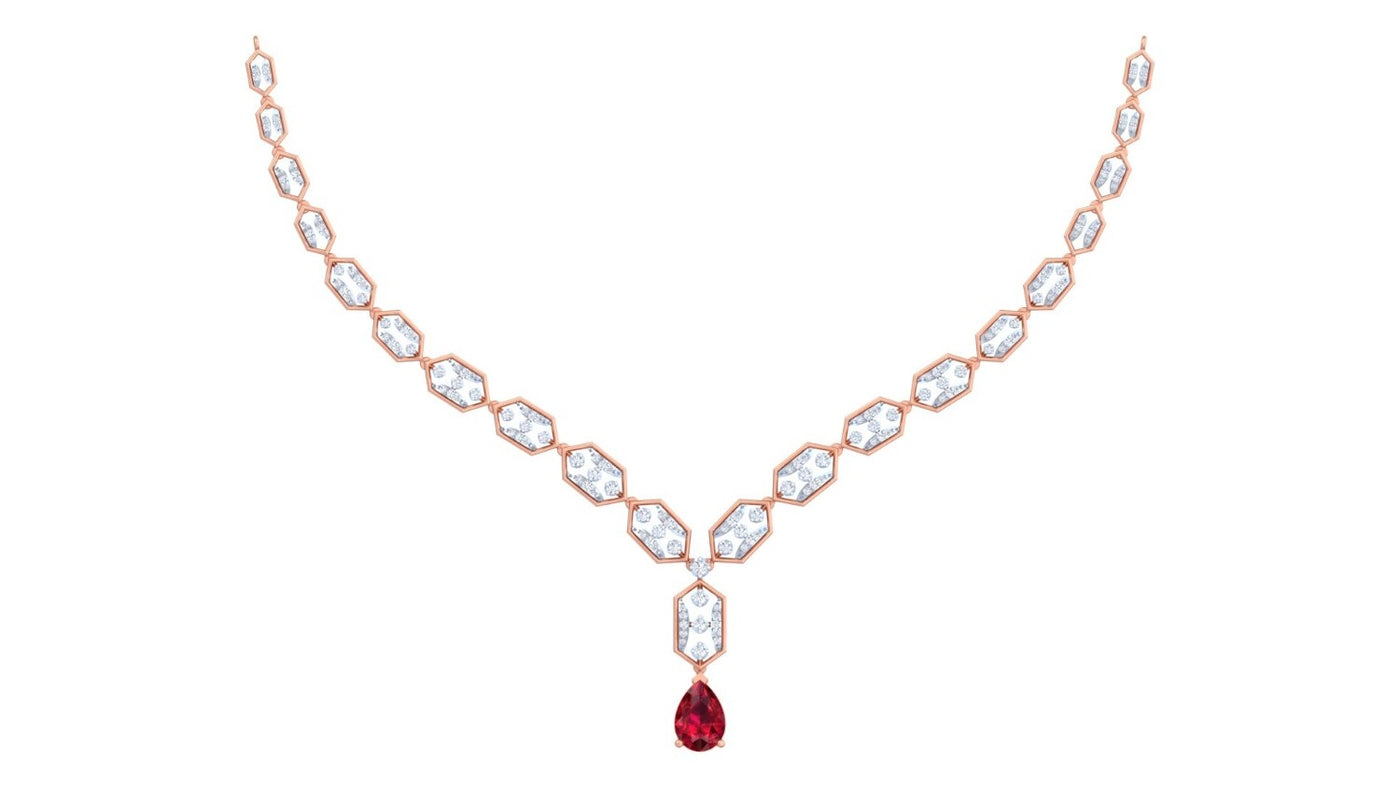 A rose gold Y-shaped necklace featuring a gemstones and a teardrop-shaped red ruby, displayed on a solid white background.