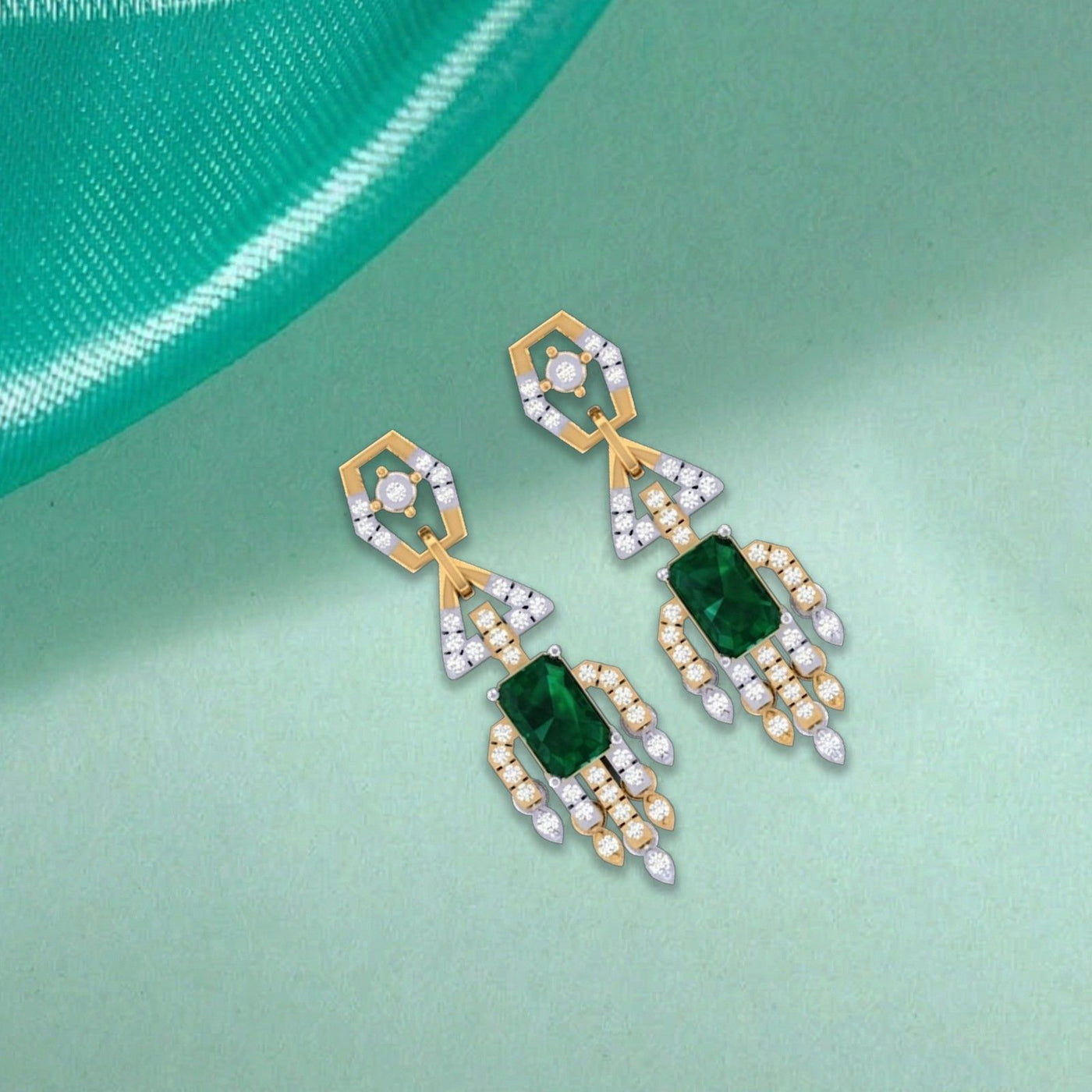 Gold and diamond dangler earrings with rectangular green emerald-cut center stones on a light green background