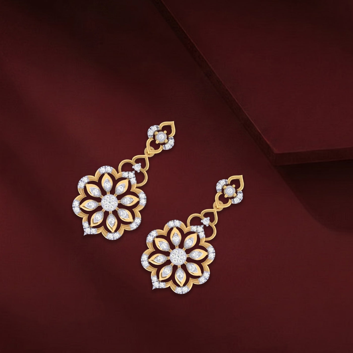 Gold and diamond floral earrings on a dark red background.