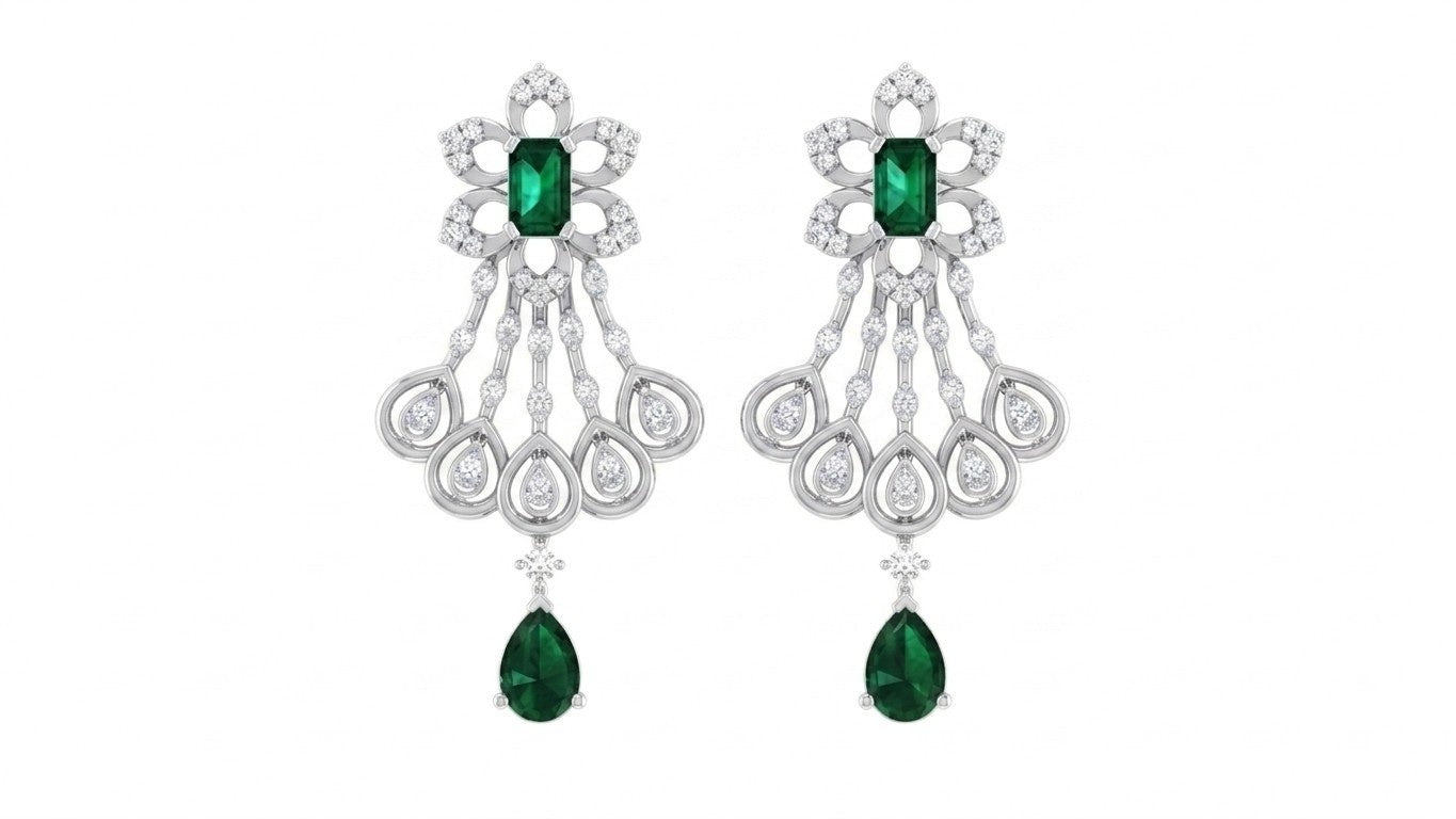 Pair of chandelier white gold earrings with green gemstones on a white background.