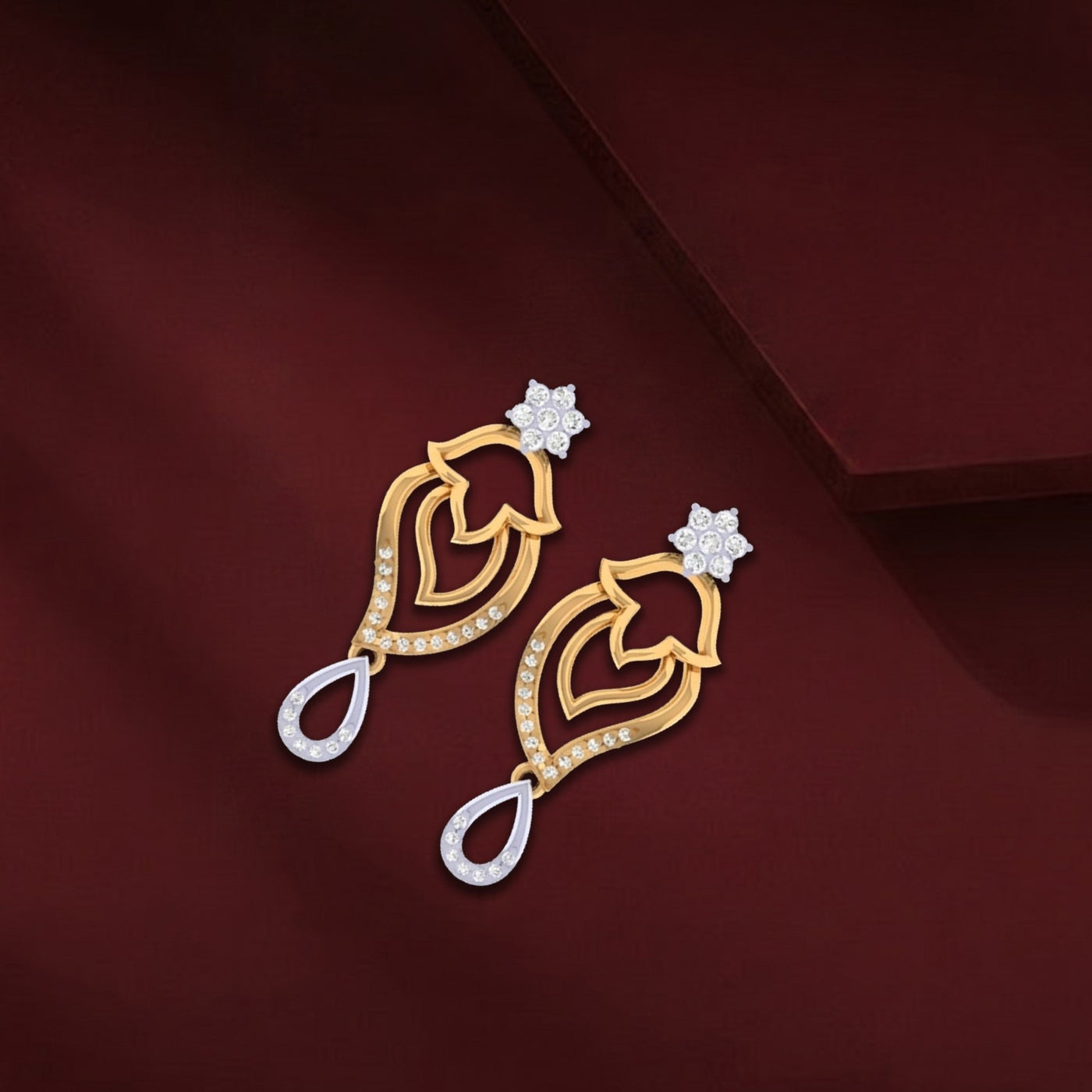 A pair of two-tone gold drop earrings featuring a diamond flower top, an openwork yellow gold body