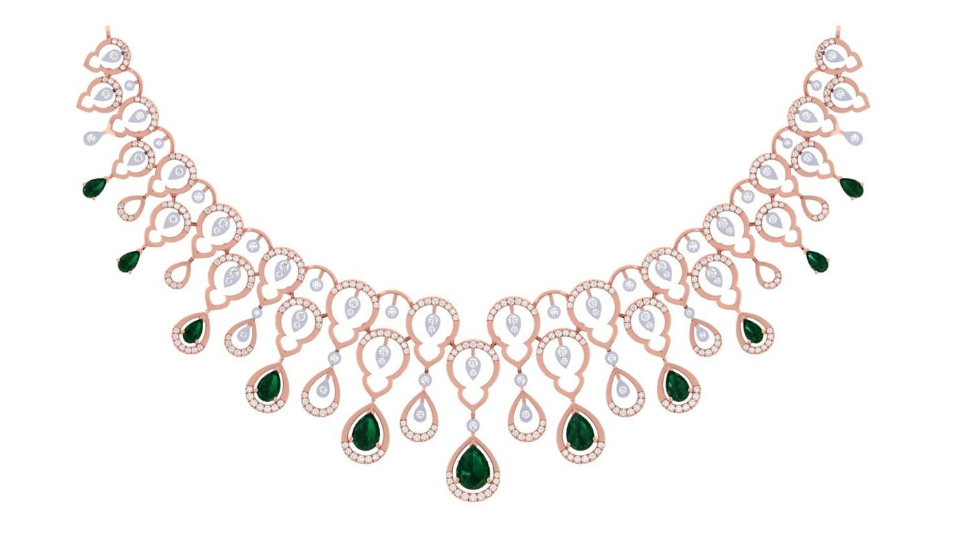 A rose gold necklace with emerald teardrop gemstone, displayed on a solid white background.
