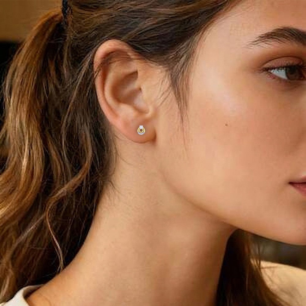 Close-up of a woman wearing a stud earring with a blurred background