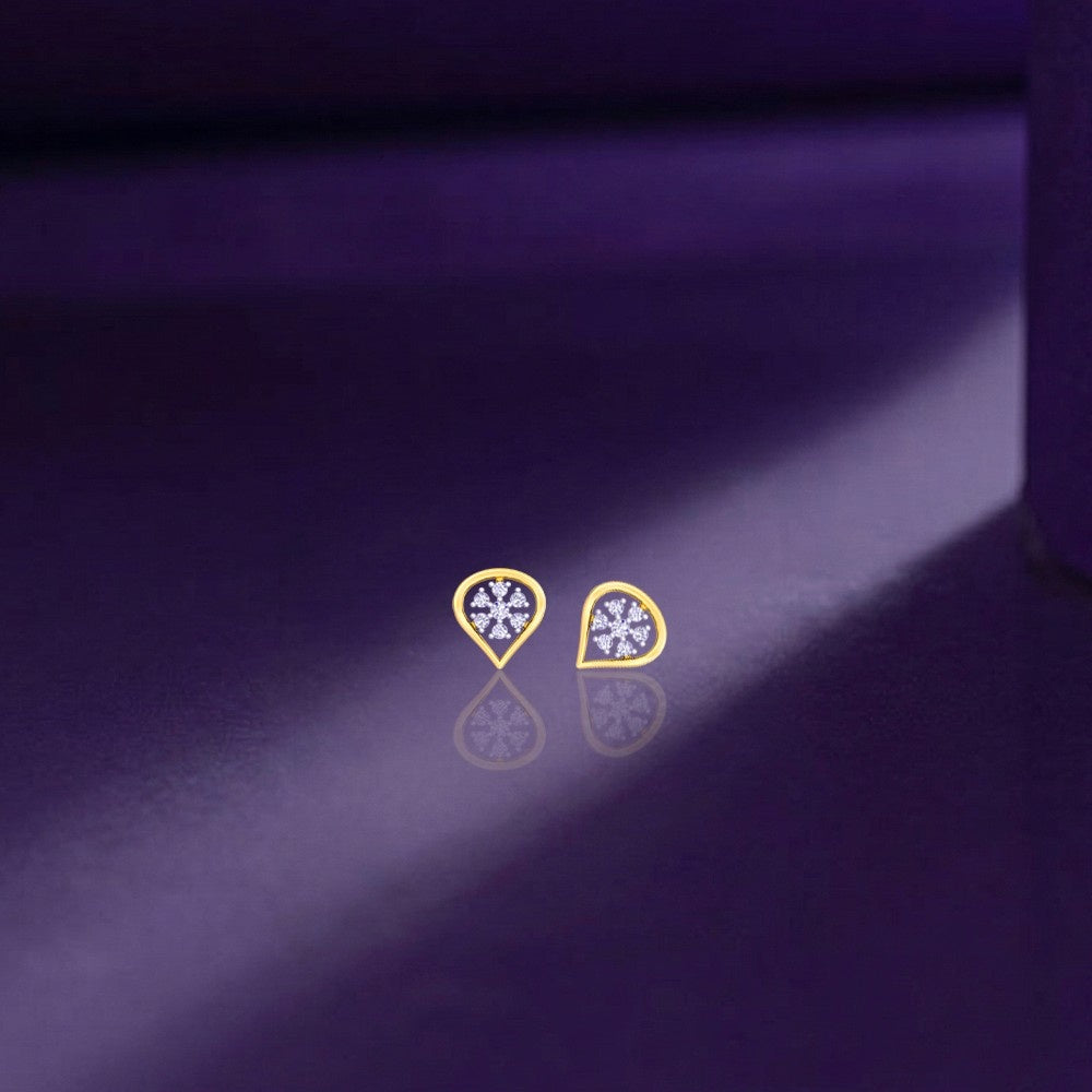 Gold and diamond stud earring on a purple background.