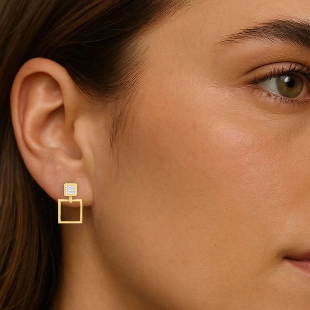 Close-up of a woman wearing gold and diamond square earrings.