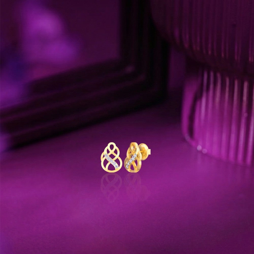 Gold and diamond dailywear stud earring on a purple surface.