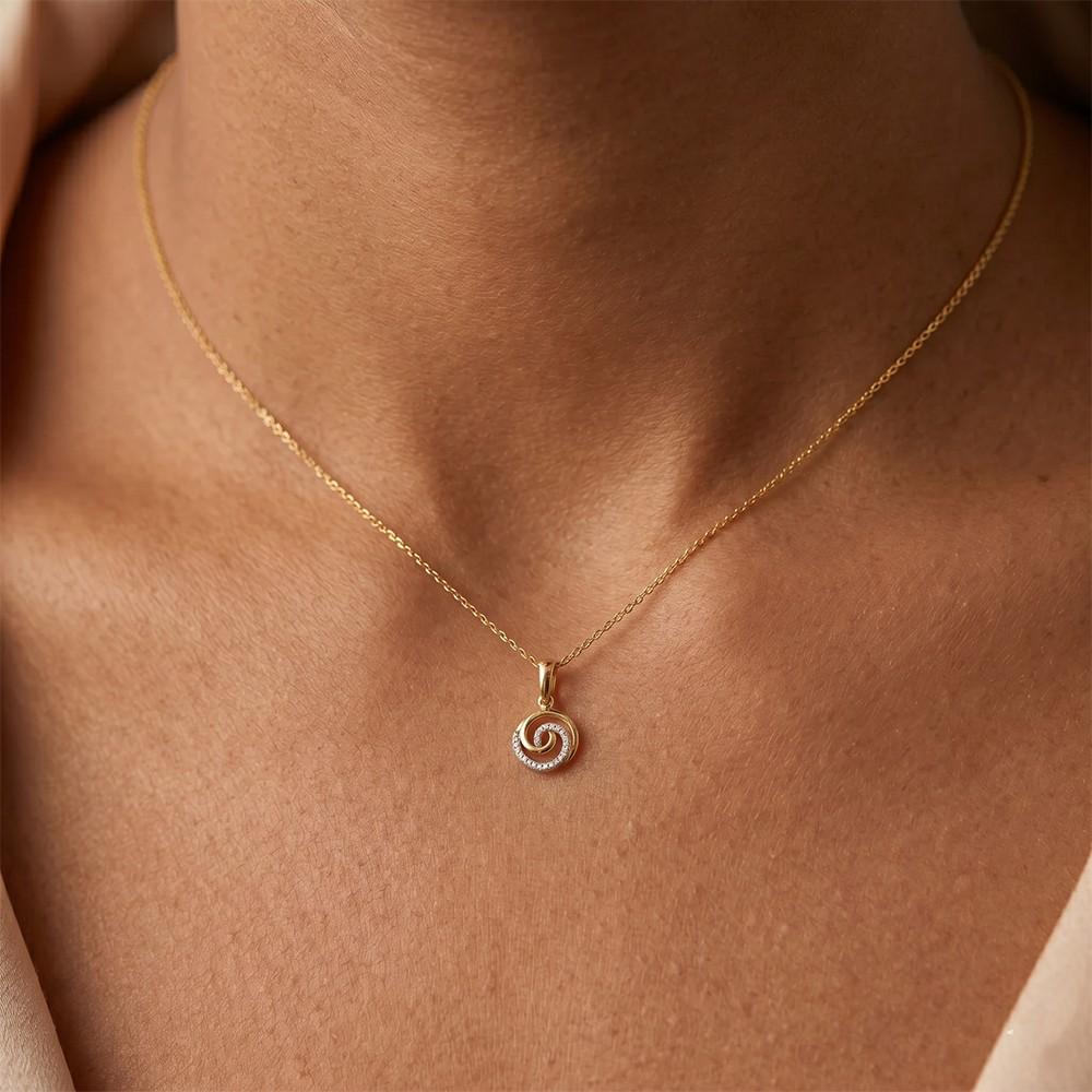 Women wearing gold and diamond spiral pendant 