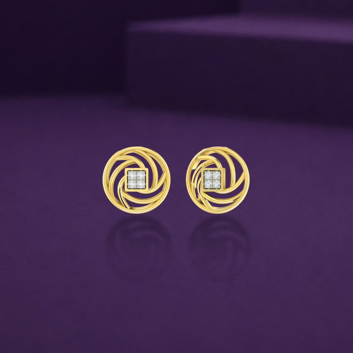 A pair of yellow gold swirl stud earrings with a diamond center on a purple background