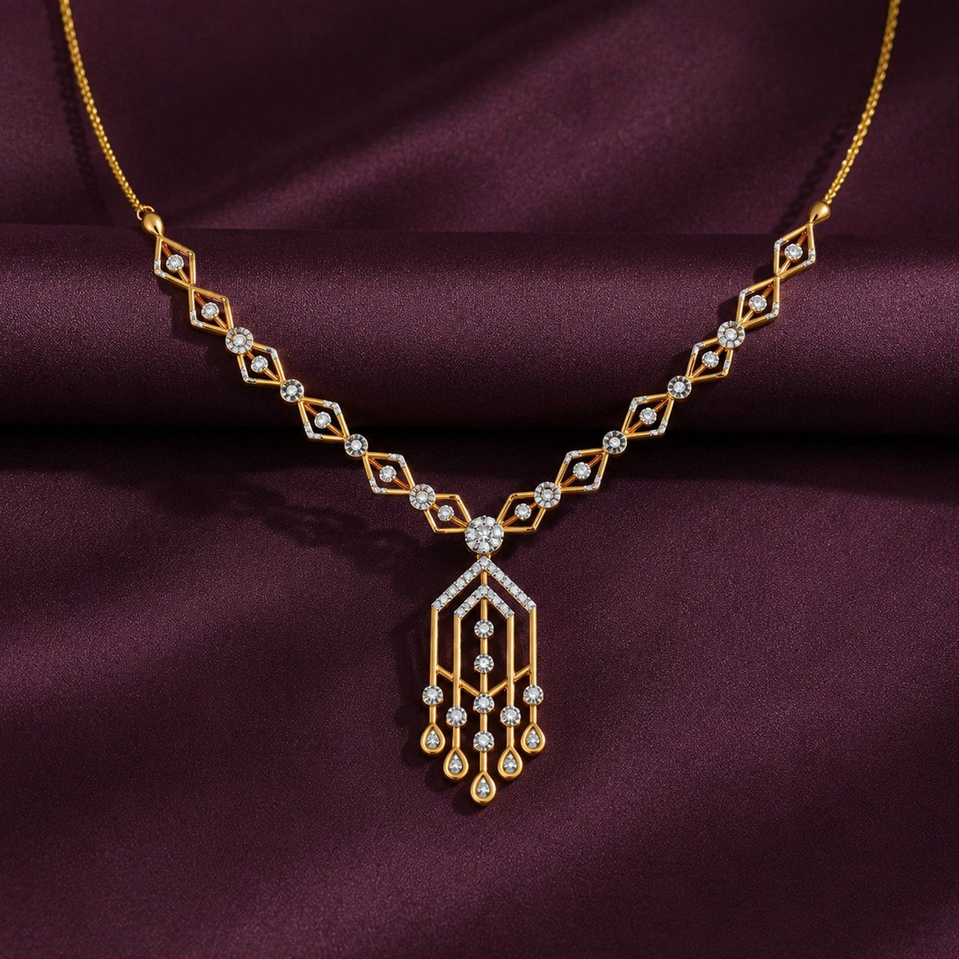 Gold necklace with diamond on a purple fabric background