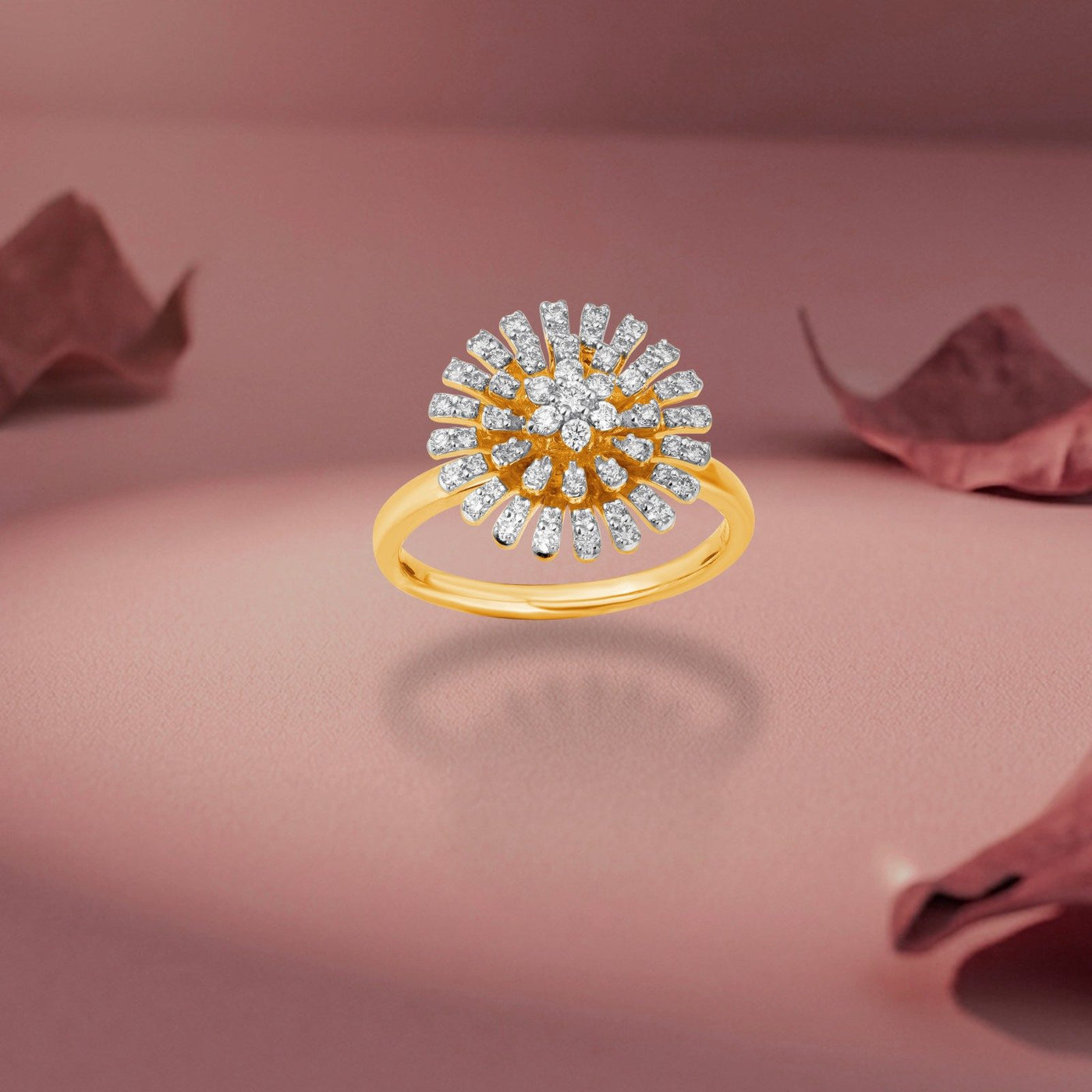 Gold and diamond with floral-design cluster setting on a pink surface background.