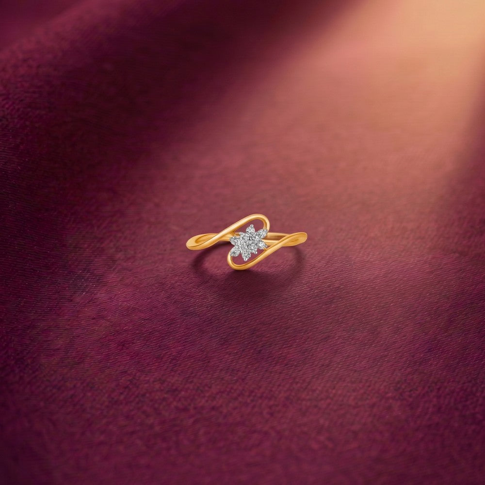 Gold and diamond with floral-design cluster setting on a red surface.