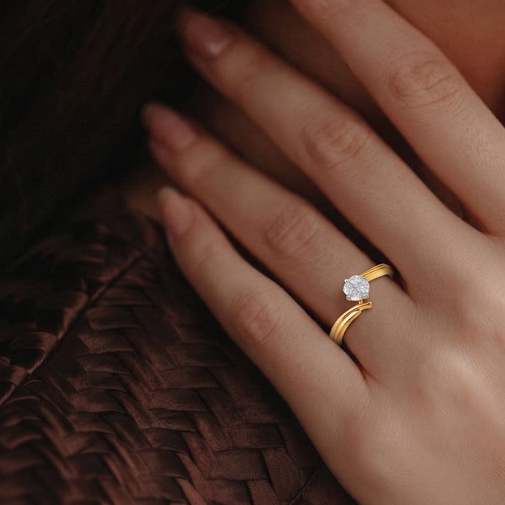 A close-up of a hand wearing a gold ring with a round clear gemstone, resting against a dark brown woven textured background.