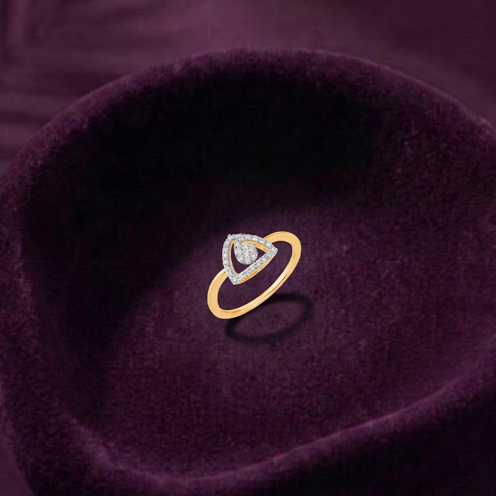 Gold and diamond with center cluster setting on a fabric surface.