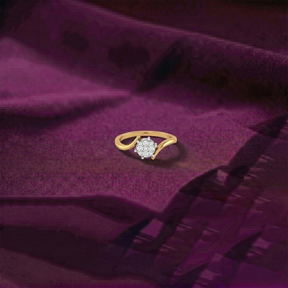 Gold and diamond with cluster design ring on a purple surface.