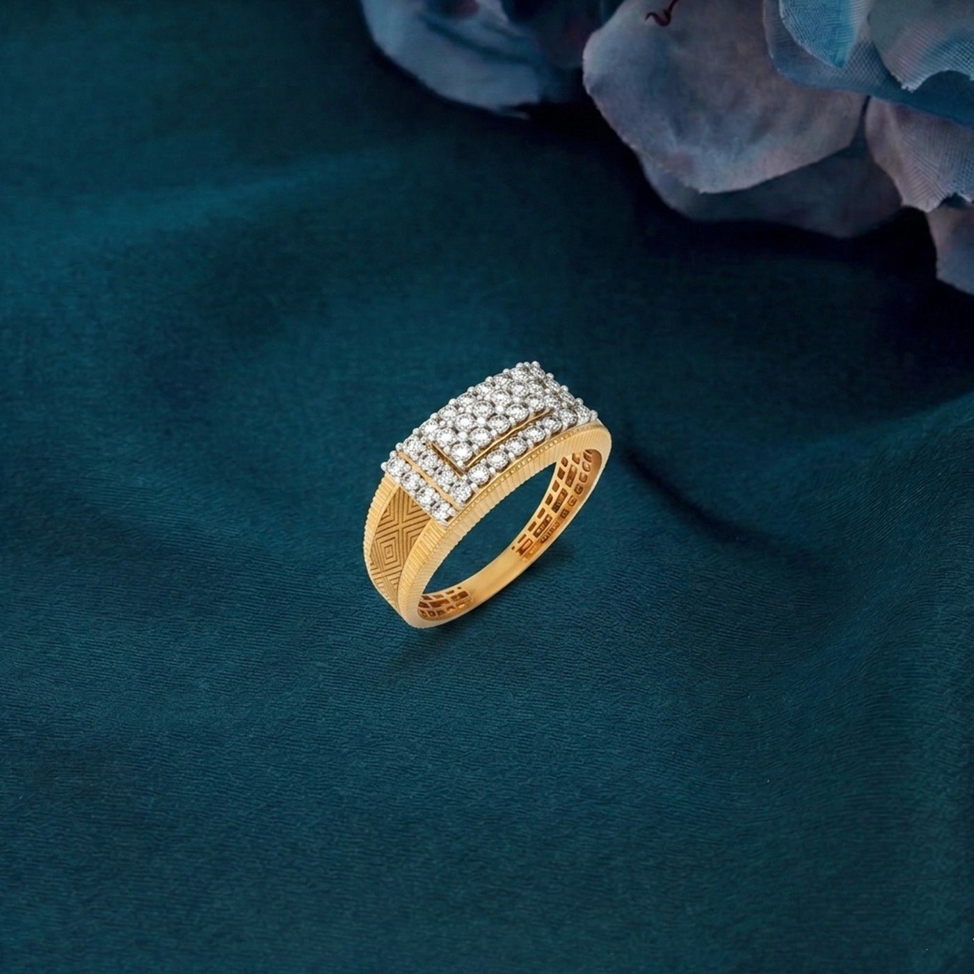 Gold ring with diamonds on a dark teal fabric background