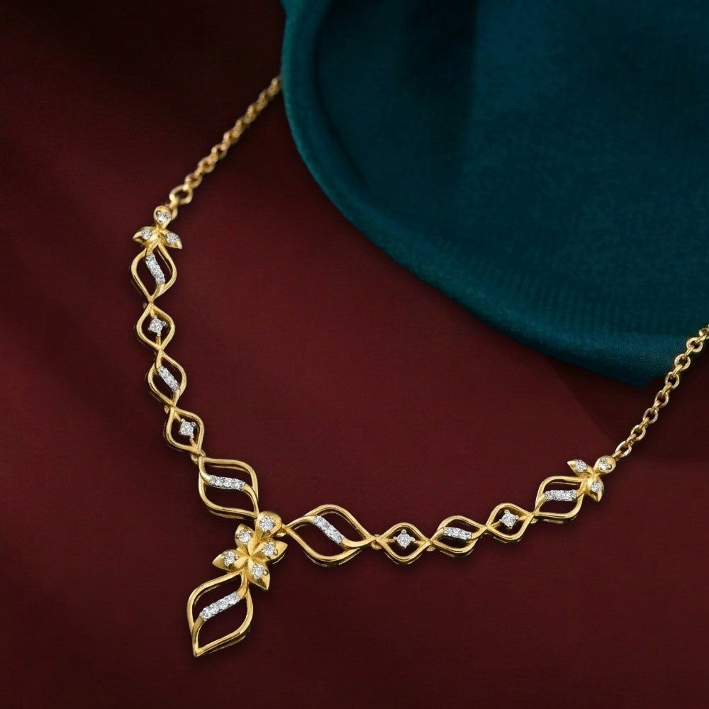 Gold and diamond necklace with diamond accents on a dark maroon background