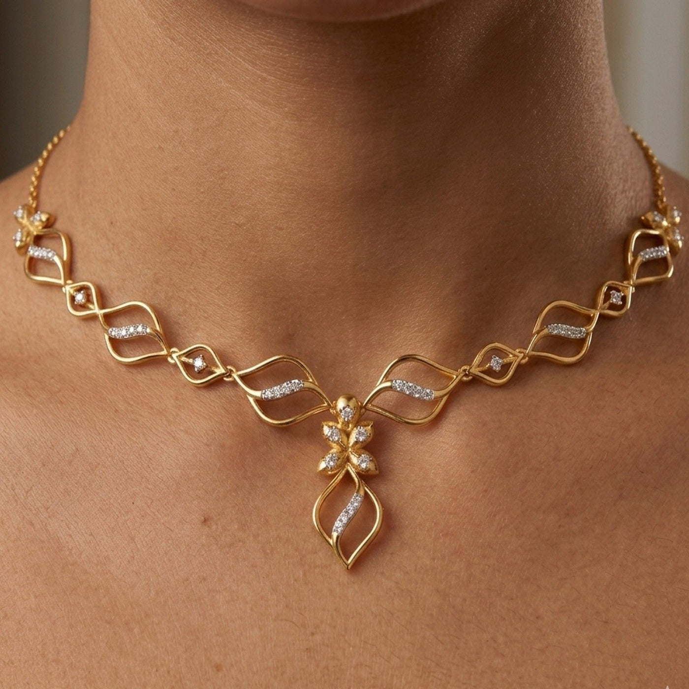 Gold necklace with diamond accents, shown worn on a model's neck.