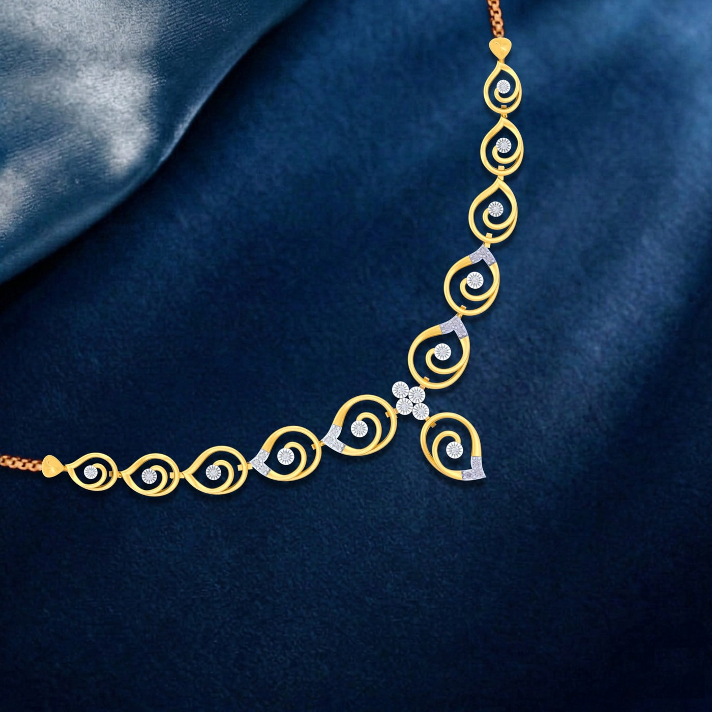 Gold and diamond necklace on a dark blue fabric background