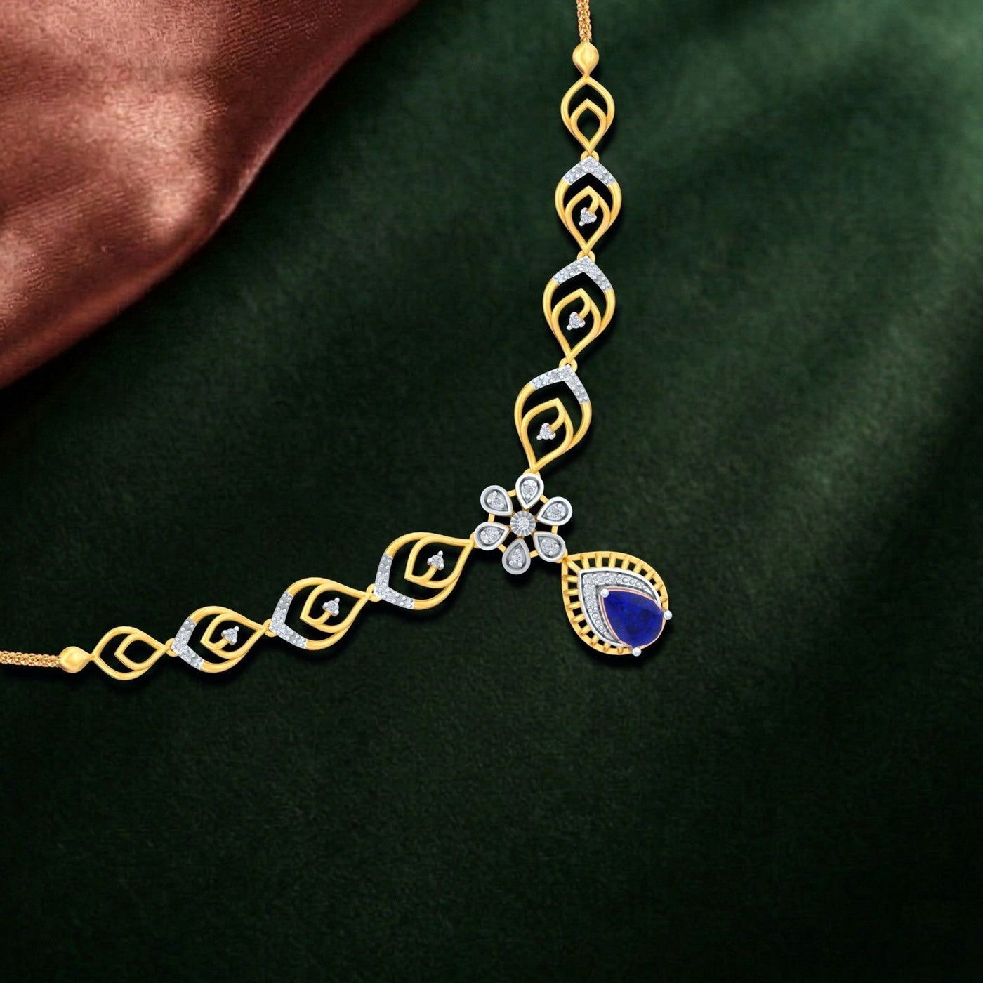 Gold and diamond necklace with a blue sapphire on a dark green background