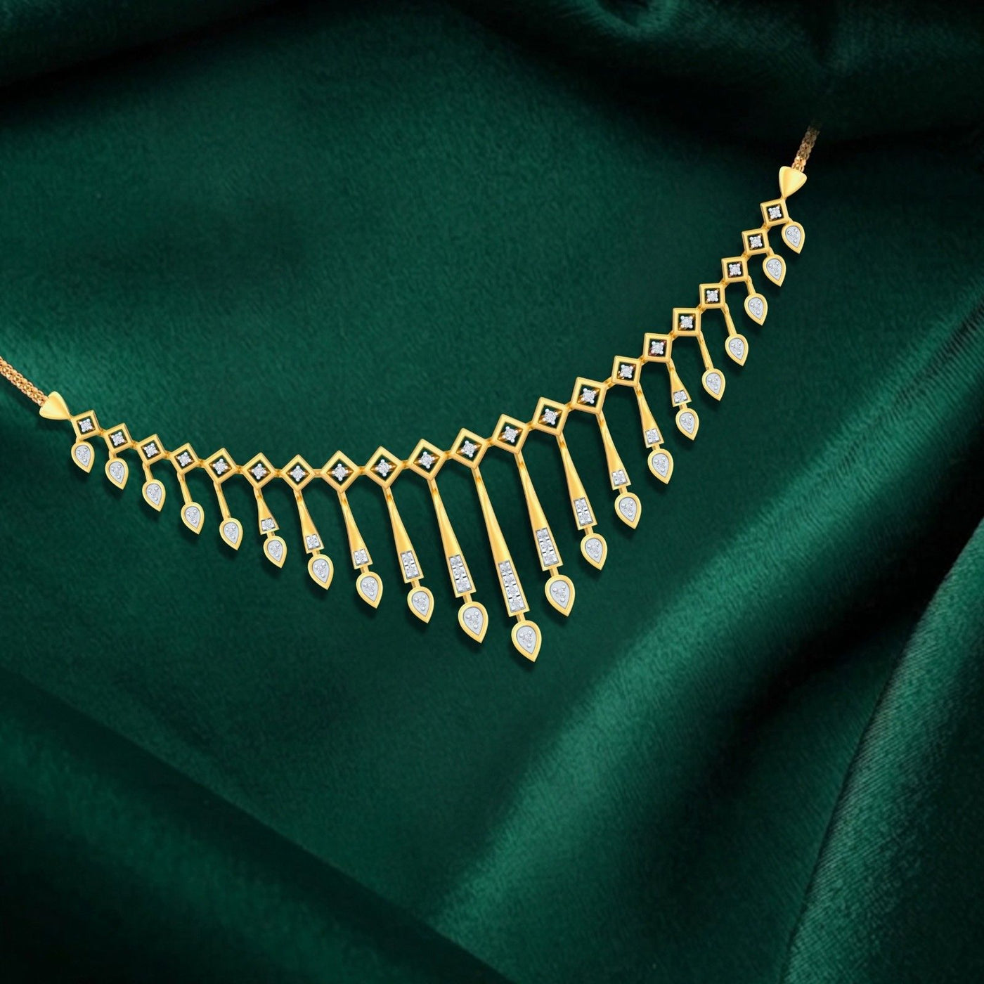 Gold necklace with diamonds on a green fabric background