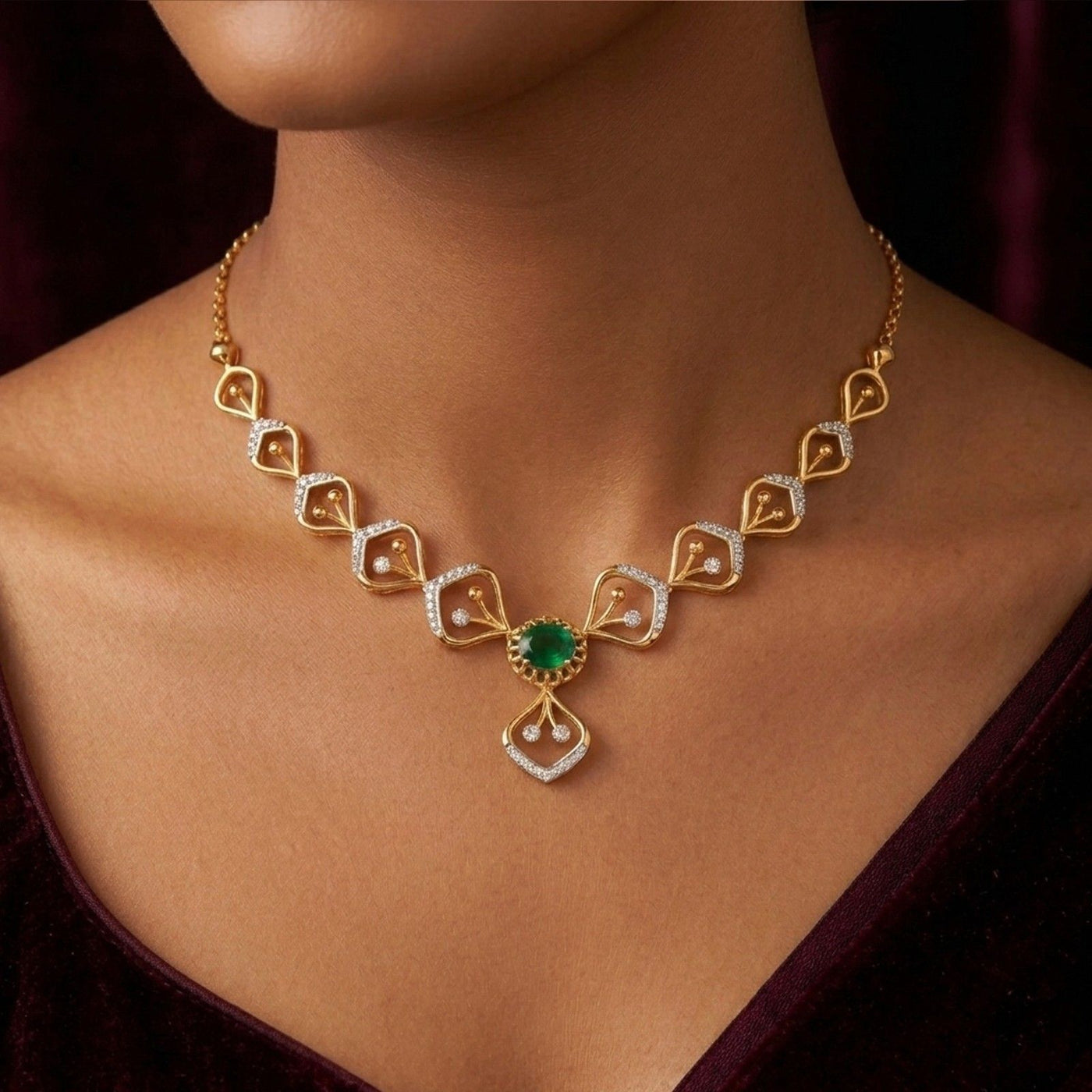 Gold and diamond necklace with a green gemstone on a person's neck against a dark background