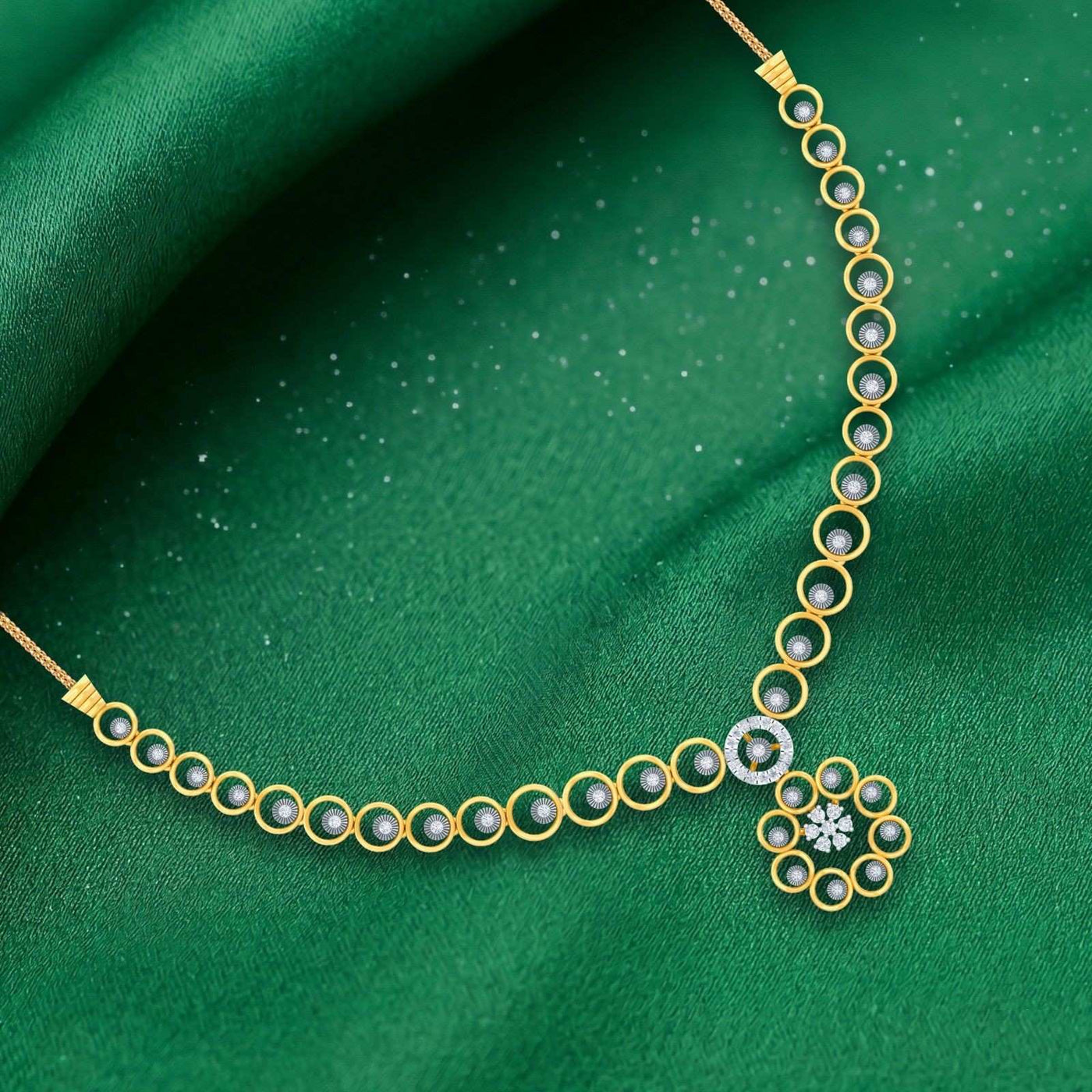 Gold and diamond with round-shaped necklace on a green fabric background.