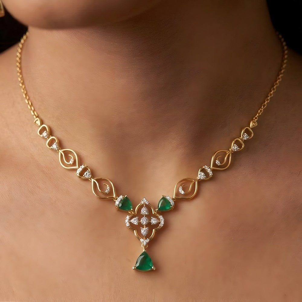 Gold necklace with emerald and diamond on a person's neck