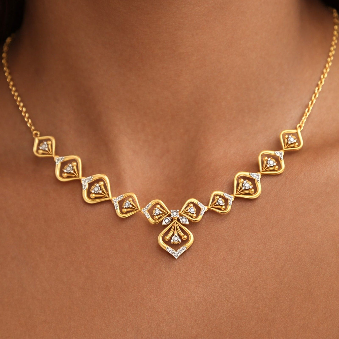Gold and diamond floral necklace worn by a person 