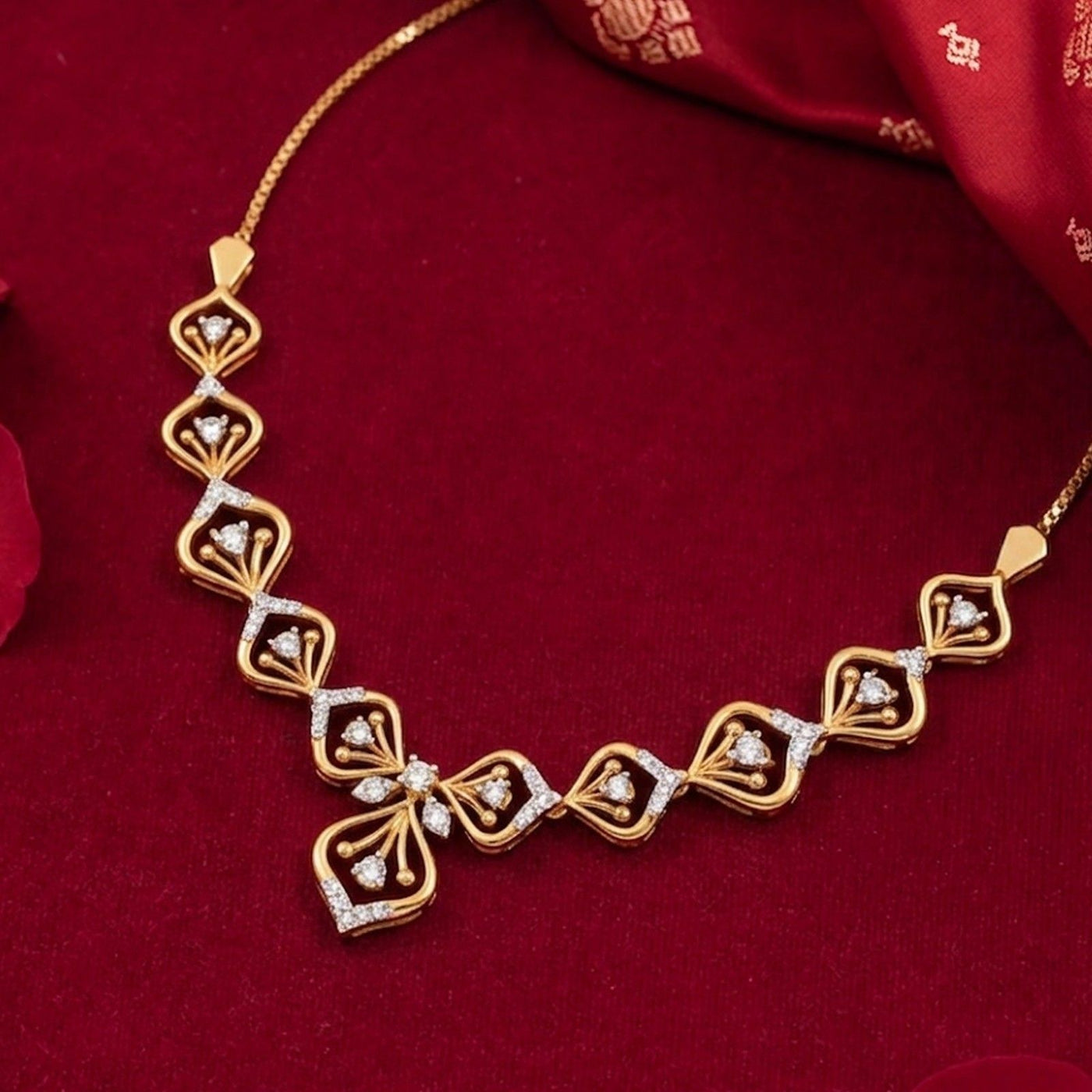 Gold and diamond necklace with floral design on a red background
