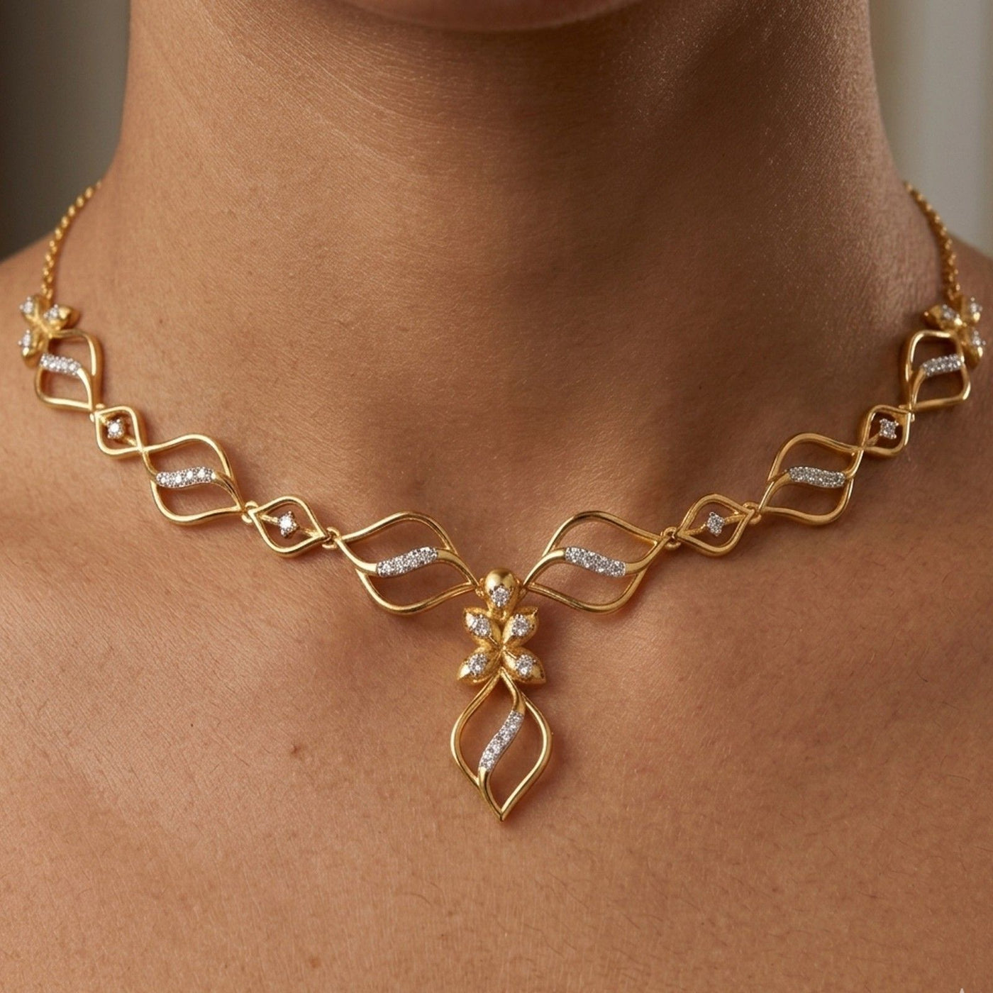 Gold and diamond  necklace worn by a person.
