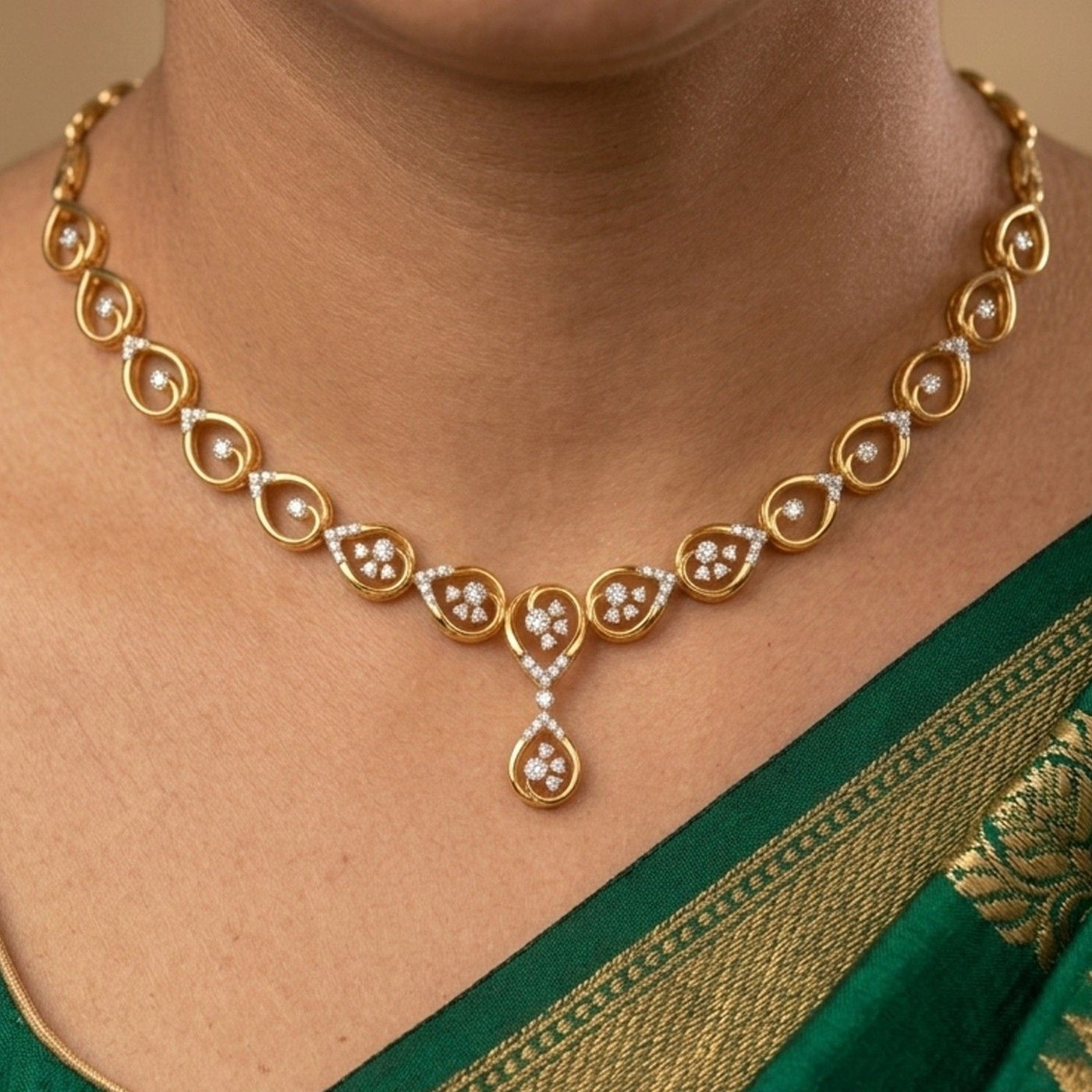 A close-up photograph of a person wearing a delicate yellow gold necklace 