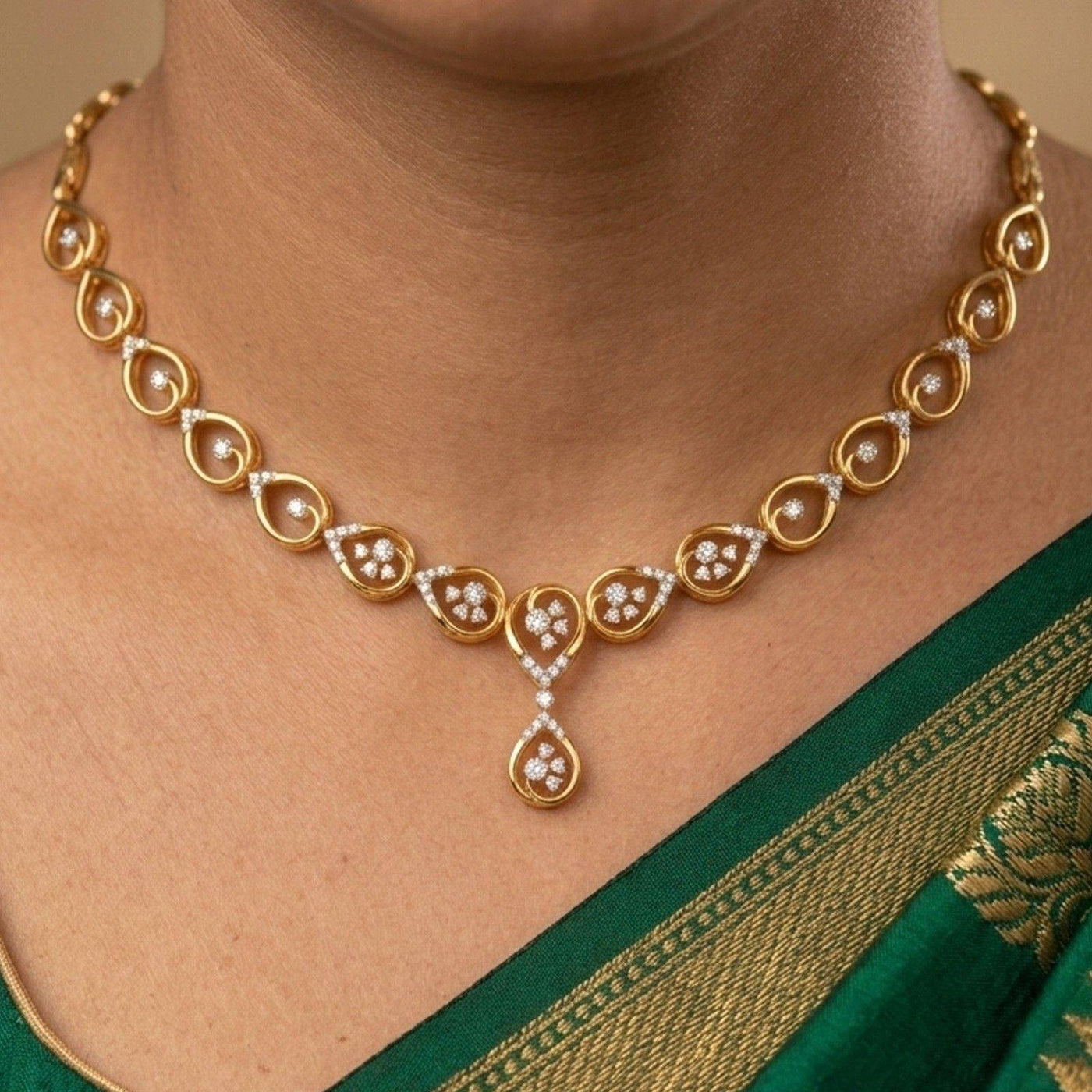 A gold necklace with diamond accents worn by a model in a green saree.