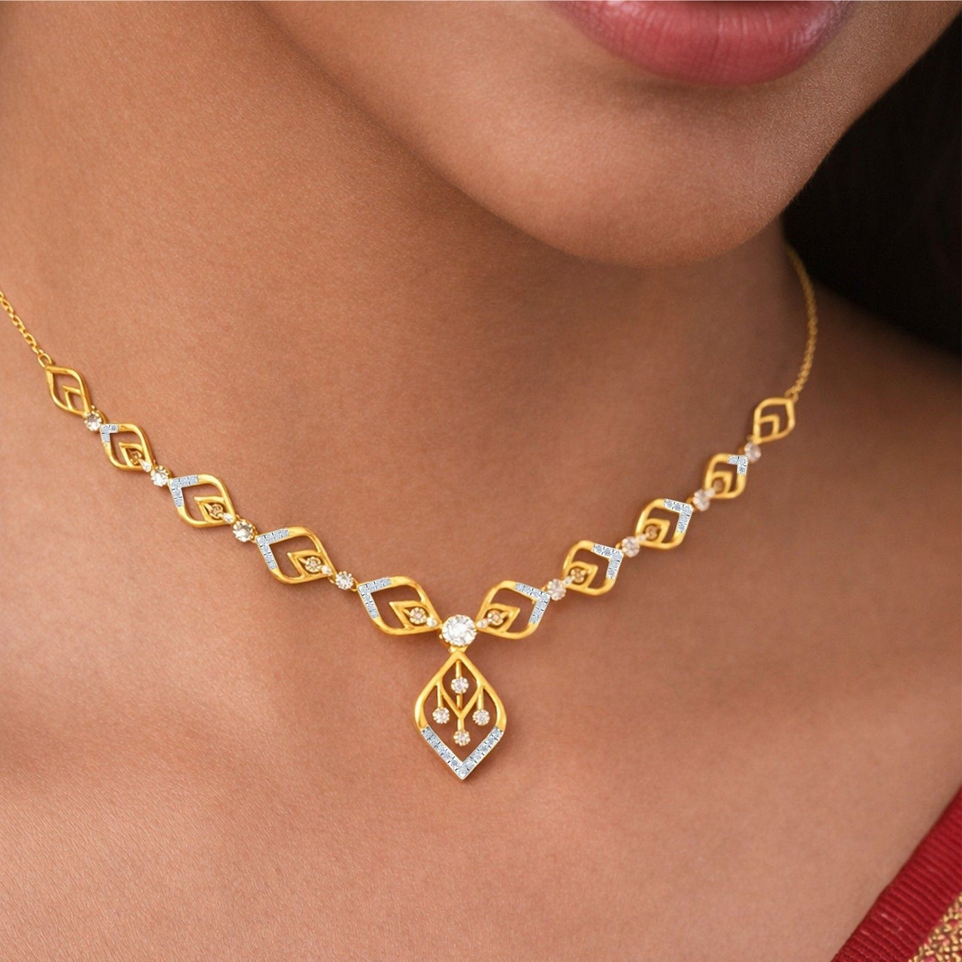 A close-up of a woman wearing a gold necklace. The necklace features repeating geometric gold links with small clear stones.