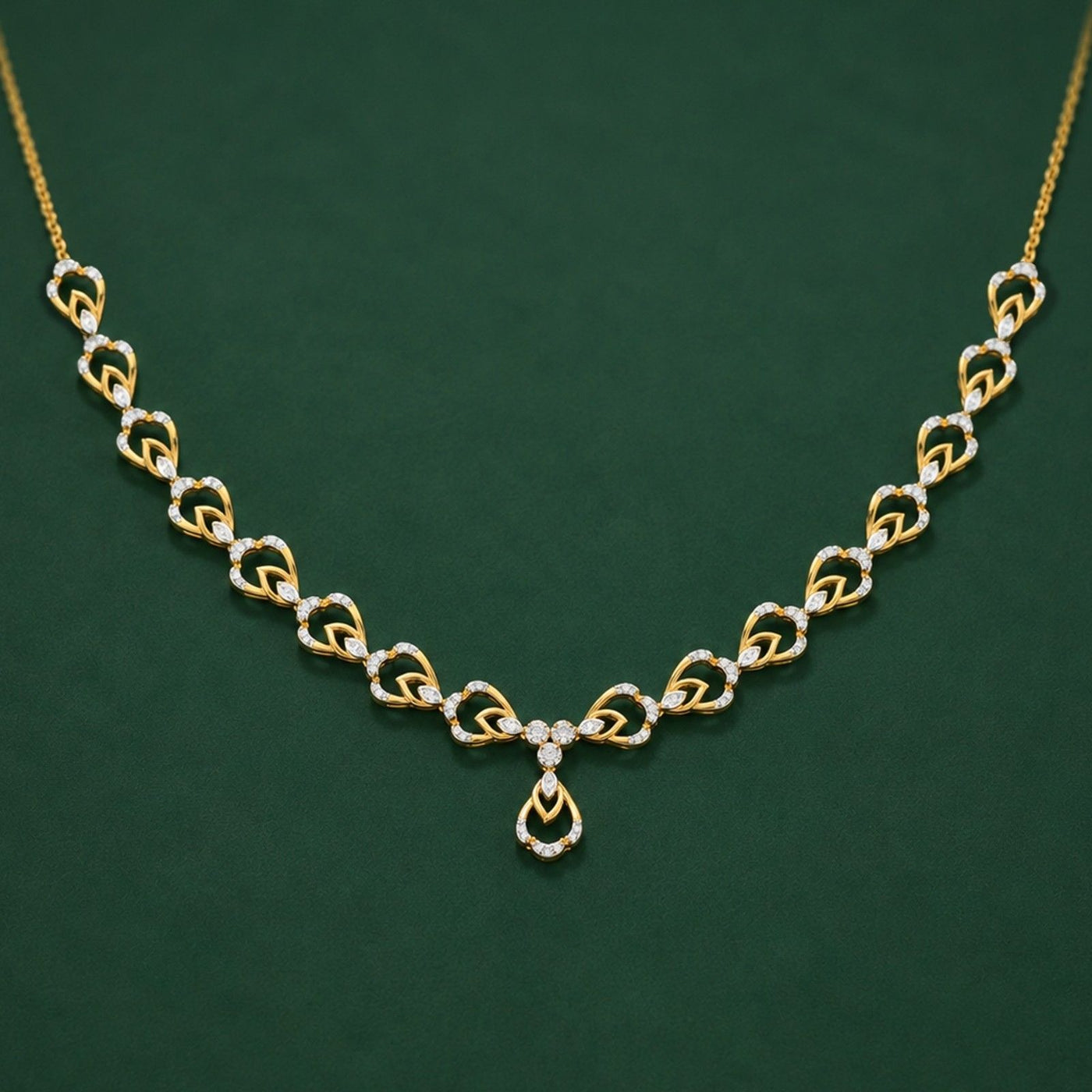 A gold and diamond necklace, displayed on a dark green background.