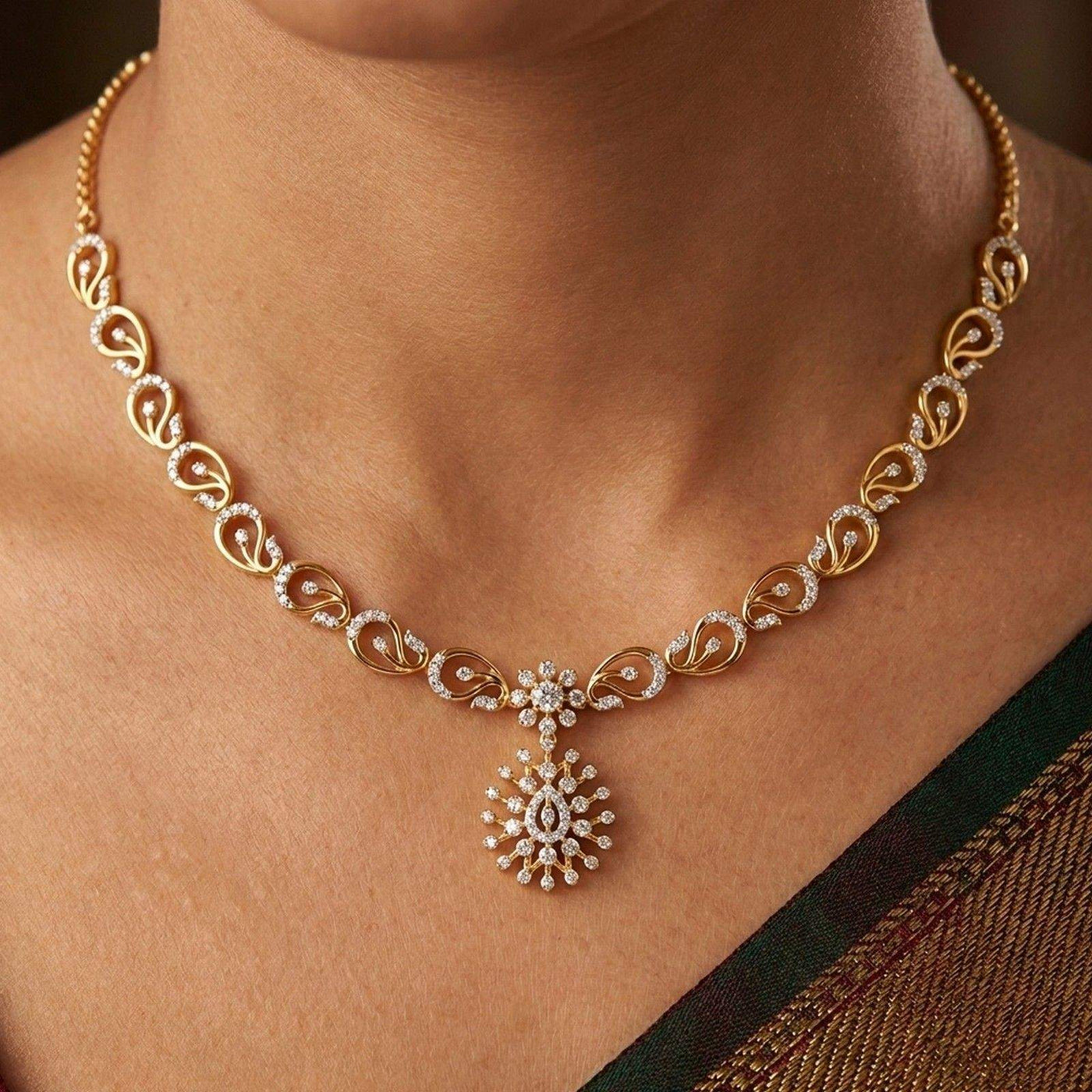 Gold and diamond  necklace featuring a repeating leaf pattern, worn on a model's neck.