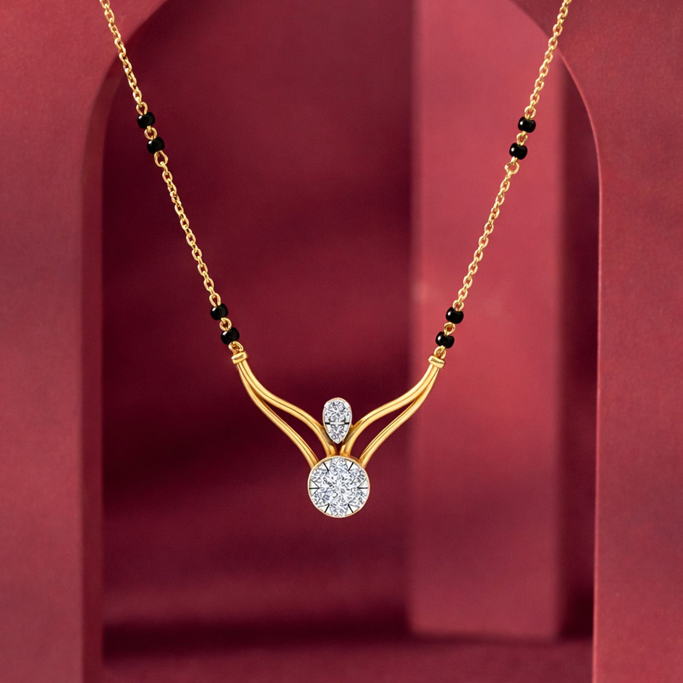 Gold mangalsutra with diamond on a red background