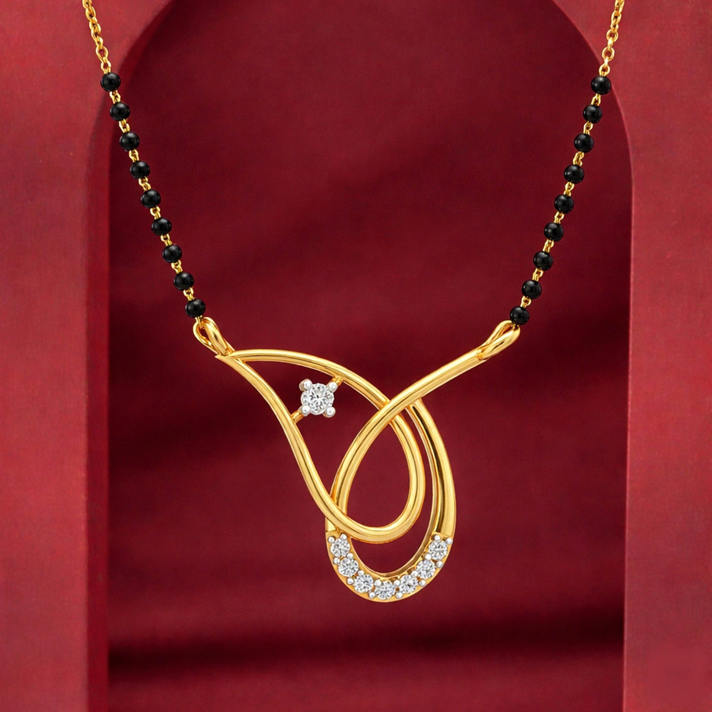 Gold pendant with a diamond on a red background