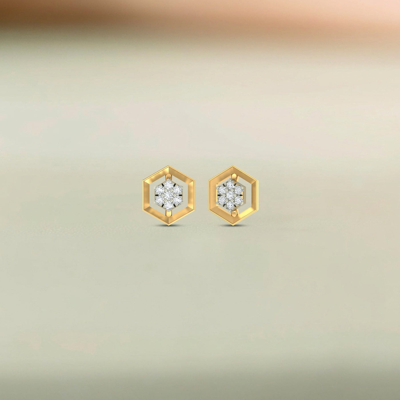 Gold and diamond earrings with diamond centers on a beige background