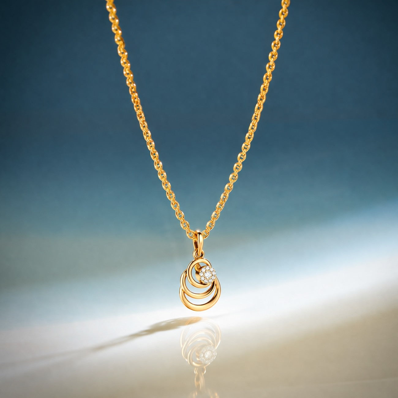 Gold necklace with a pendant on a gradient blue and beige background