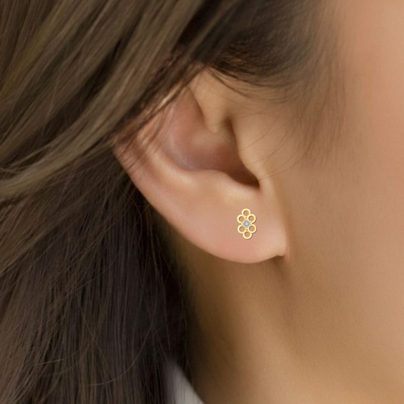Women wearing gold and diamond floral earrings 