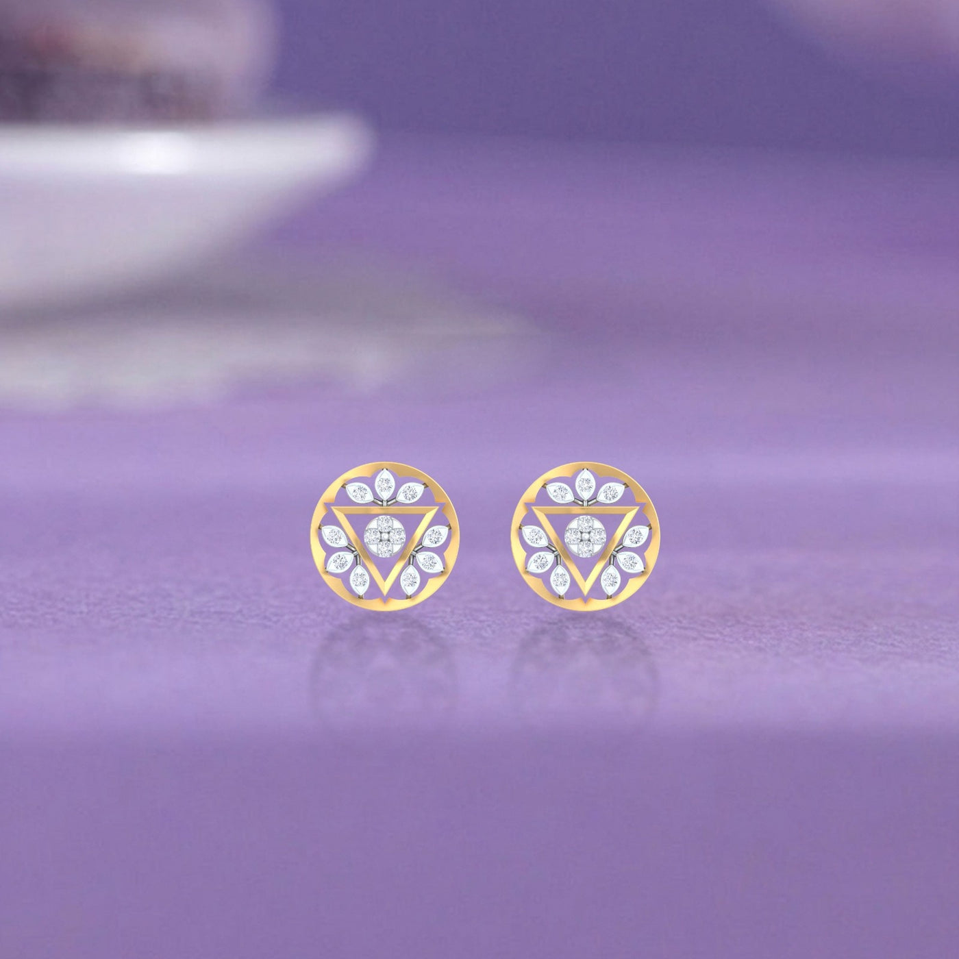 Gold and diamond round-shaped stud earrings with triangular design on a purple background