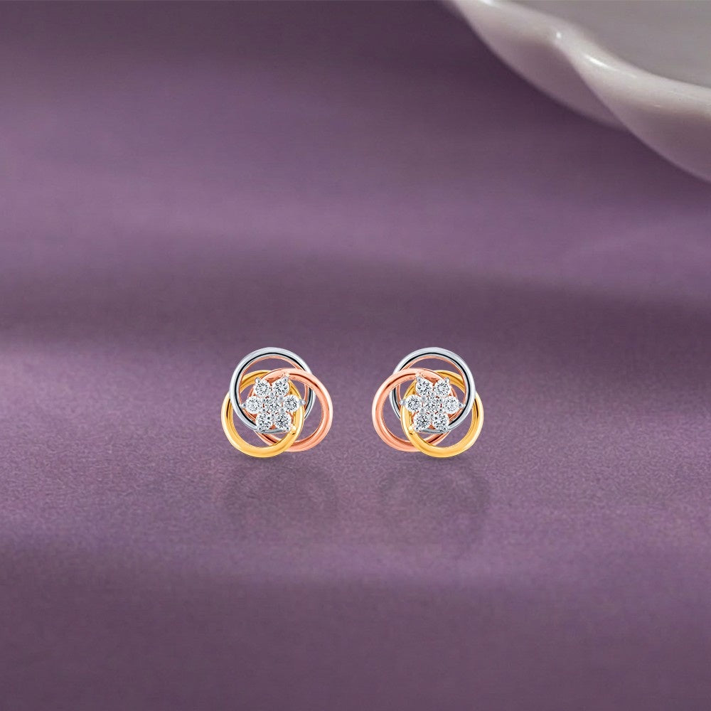Yellow gold and diamond stud earring with floral-shaped on a purple background