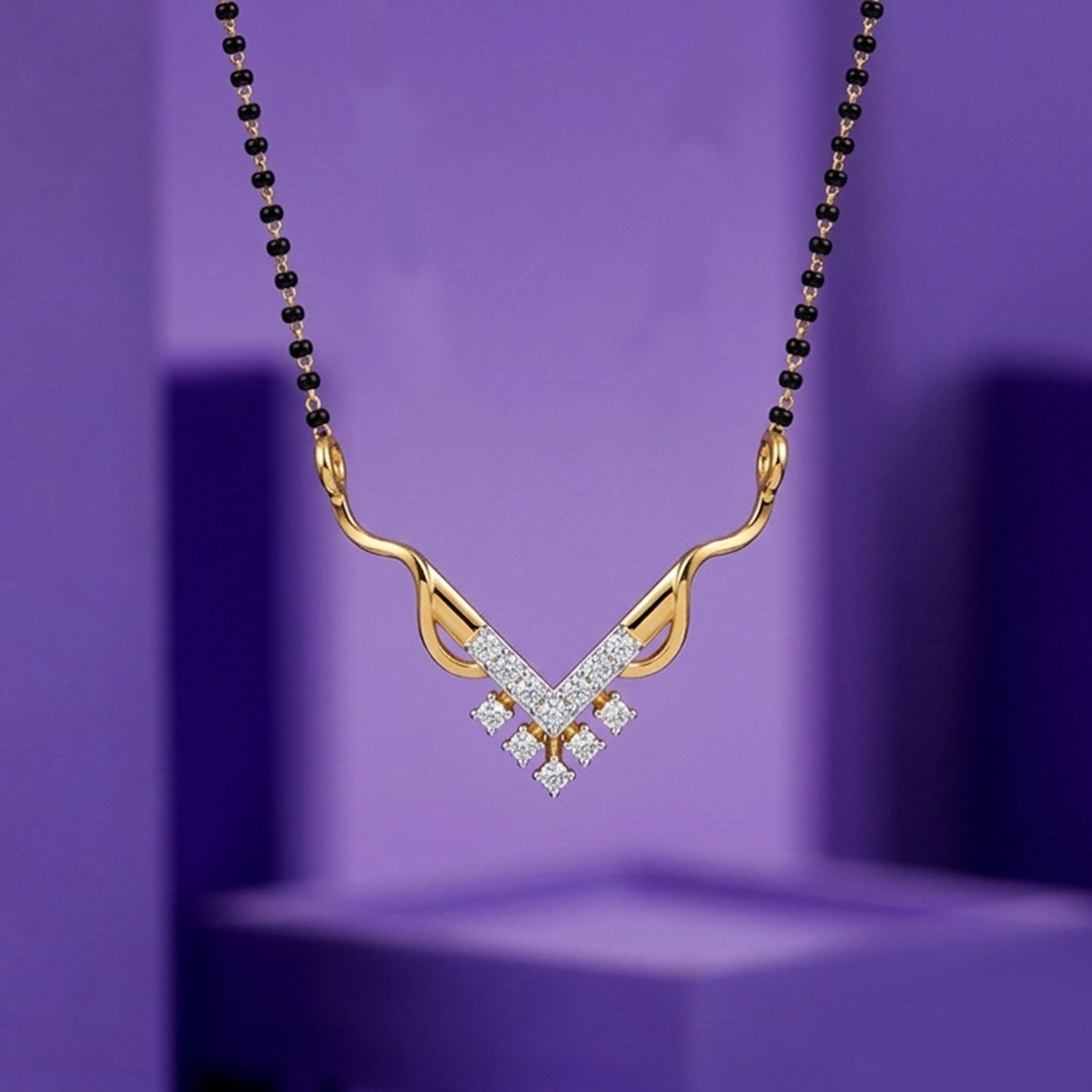 Yellow gold & diamond beaded mangalsutra on purple background