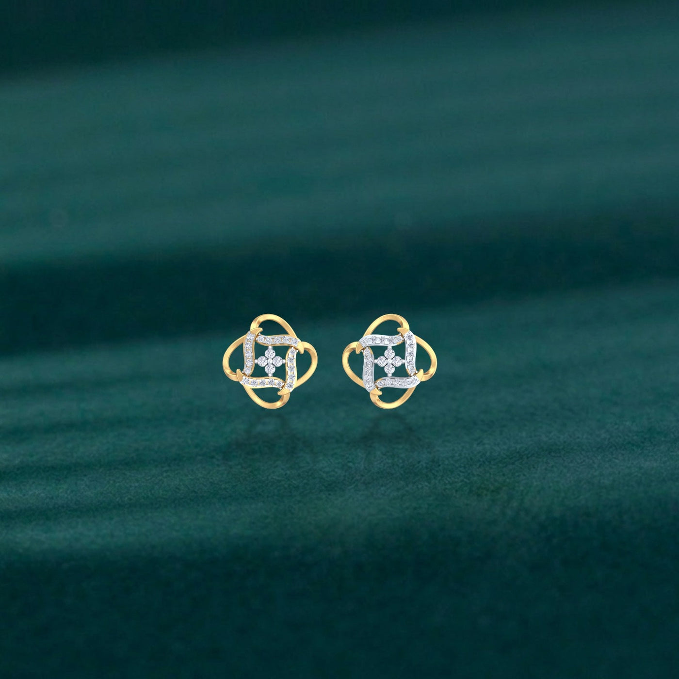 Gold and diamond floral-design stud earrings on a teal background.